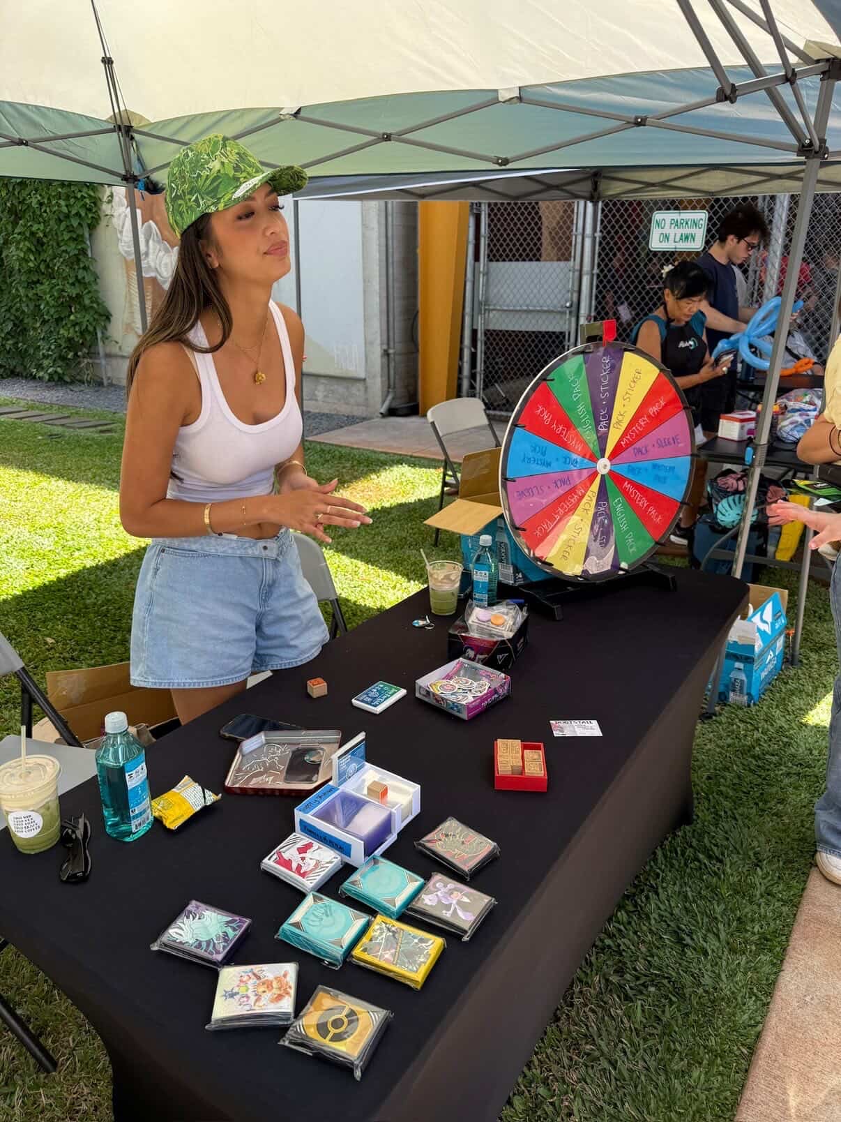Vendor running a Pokemon-themed prize wheel with mystery pulls and prizes at their booth at the Keep It Aloha Card Show