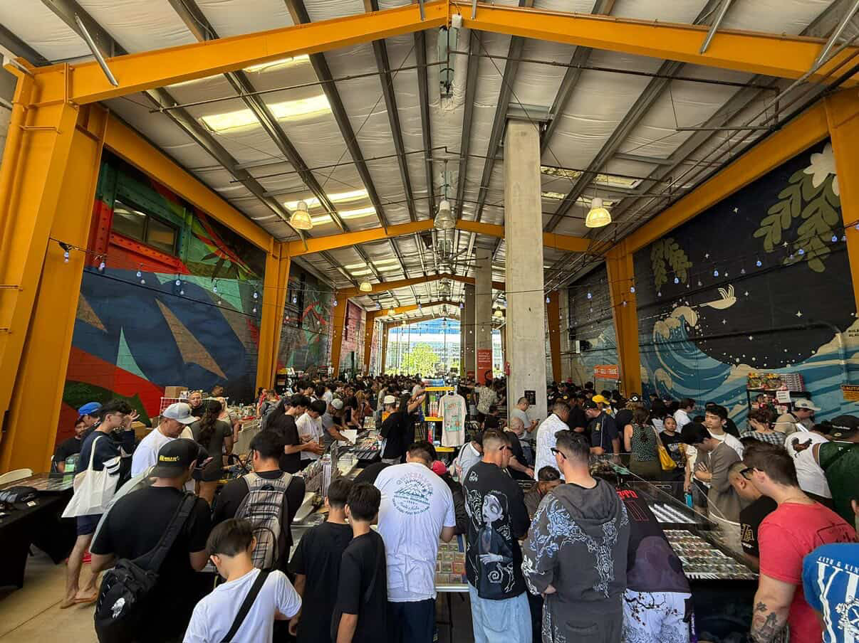 Packed card show floor at SALT at Our Kaka'ako with vendors, collectors, and families browsing tables