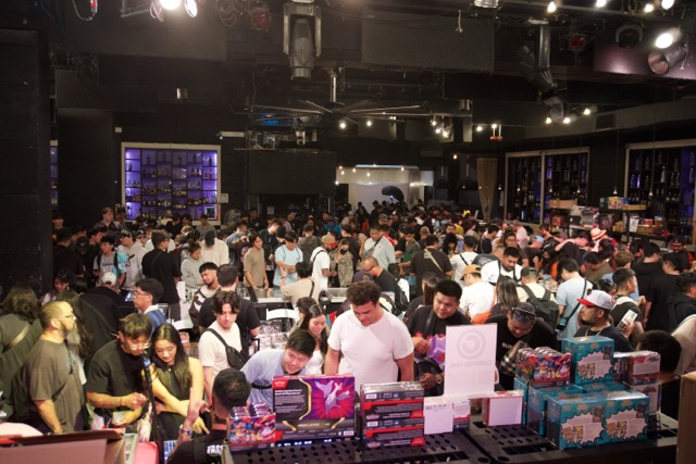 Wide view of Paradise Card Show from the stage at The Republik in Honolulu, showing rows of vendor tables and collectors browsing